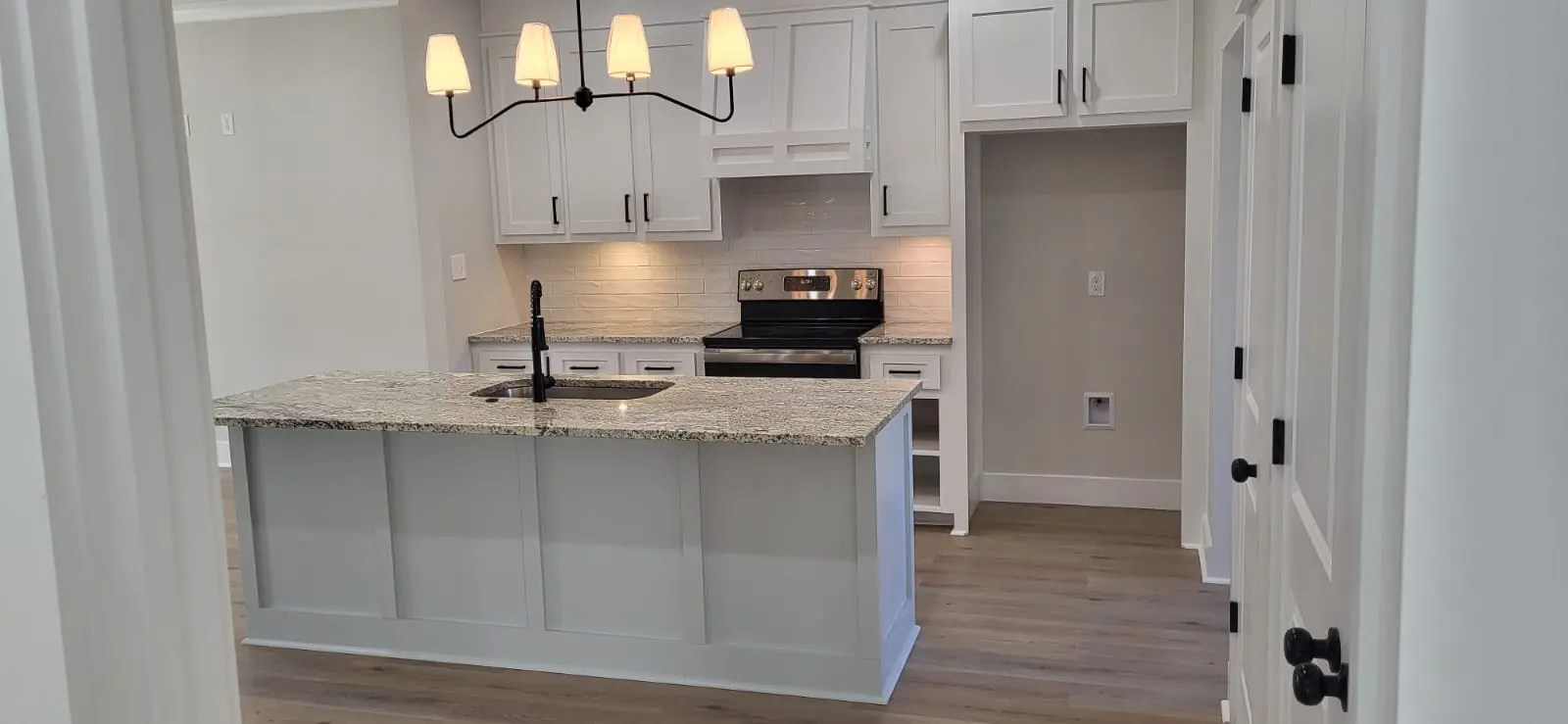 White shaker kitchen cabinets and pendant lighting, kitchen remodel in Hattiesburg, MS