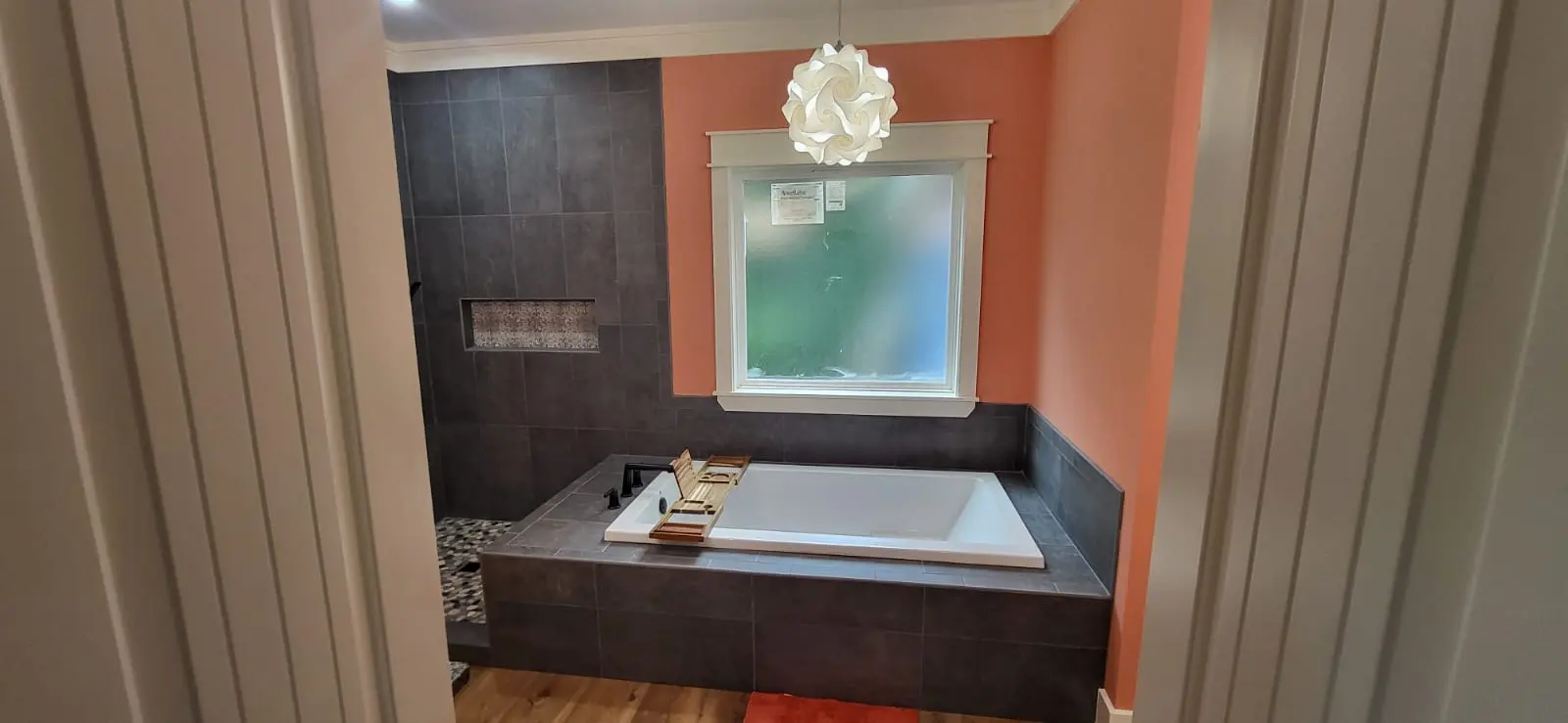 Dark tile bathroom remodel with soaking tub in Hattiesburg, MS