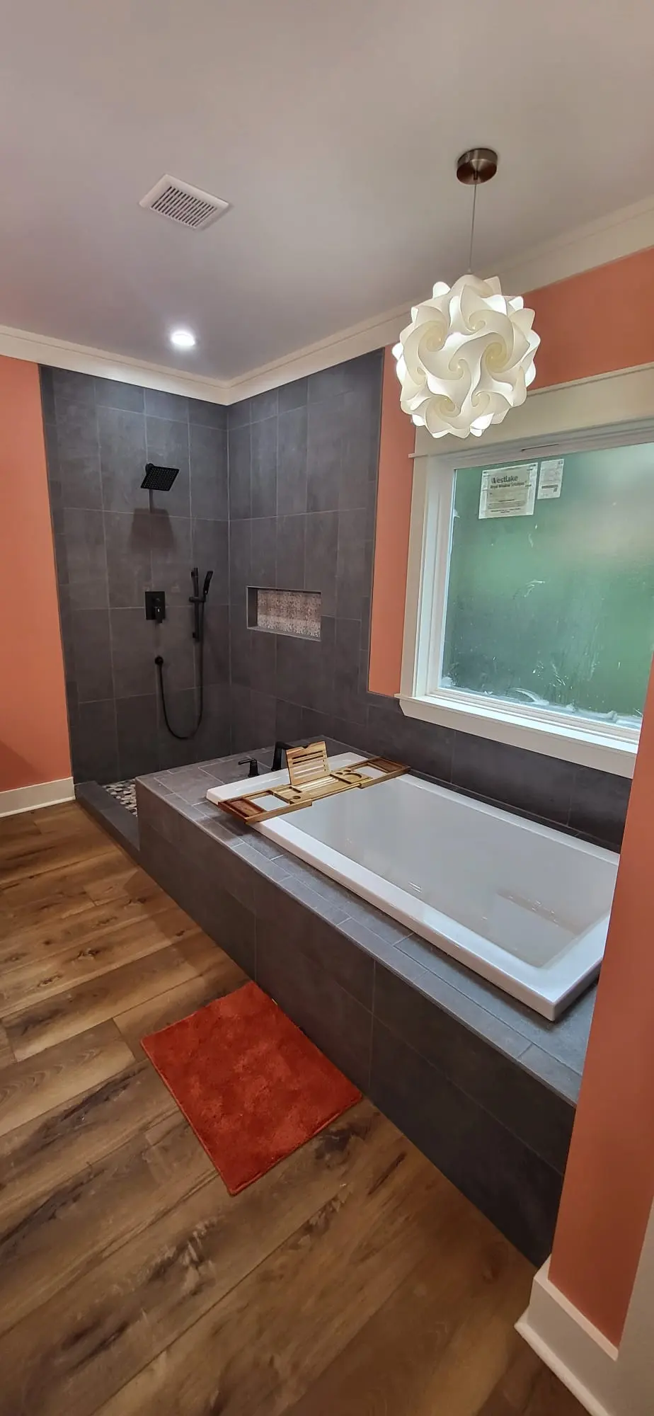 Dark tile walk-in shower and freestanding tub, custom bathroom remodel in Hattiesburg, MS