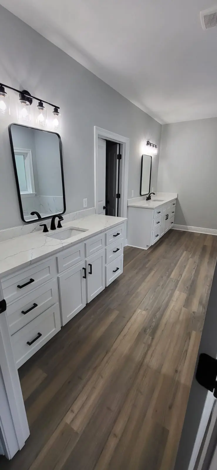 Dark tile bathroom remodel with freestanding soaking tub in Hattiesburg, MS